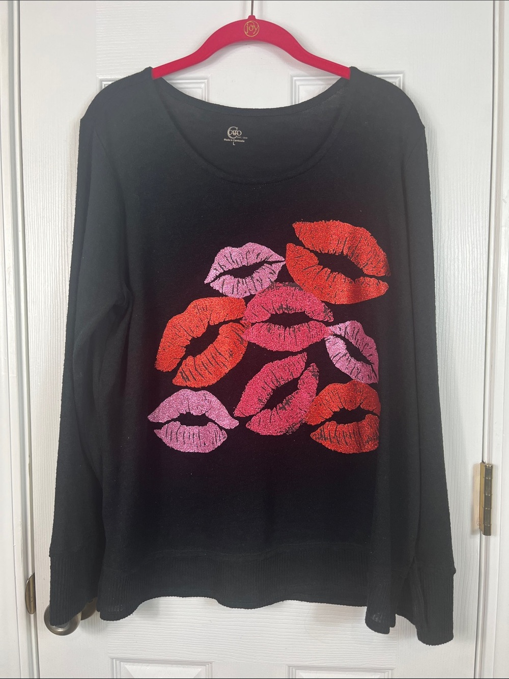 Cato black thin long sleeved sweater size large. Has glitter lips on front.
